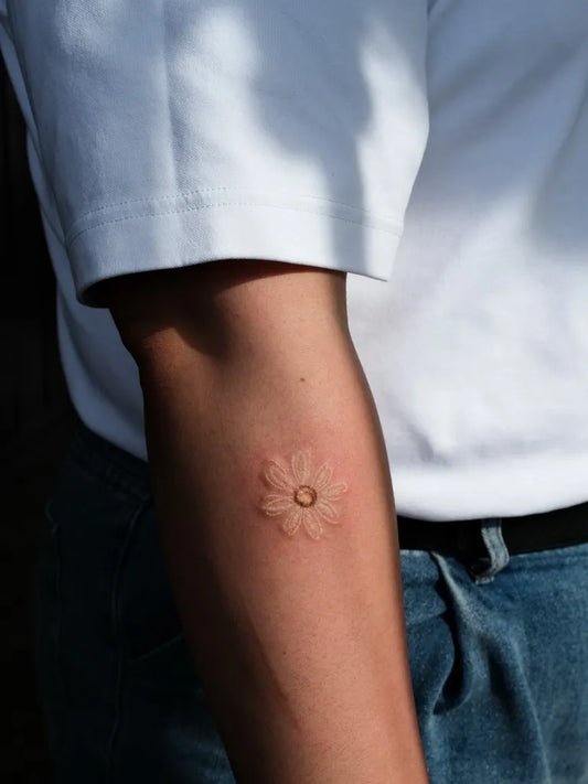Small Fine Line Daisy Tattoo on Men Arm by @sinewpark_tt