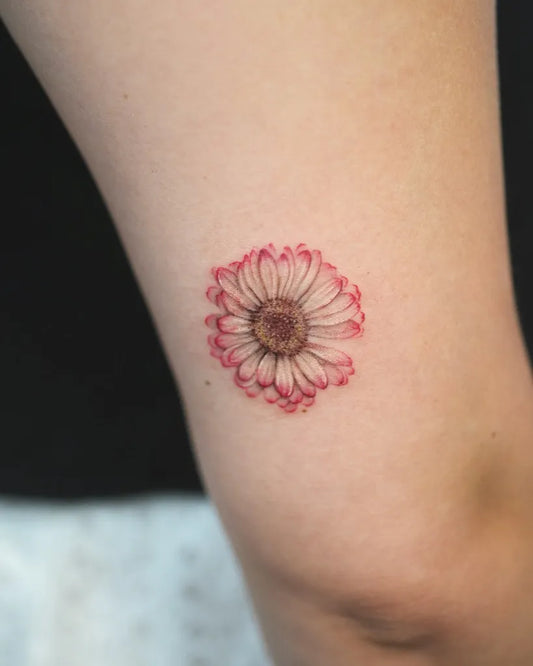 Small Fine Line Daisy Tattoo on Women Thigh by @tattoo.by_jinnie