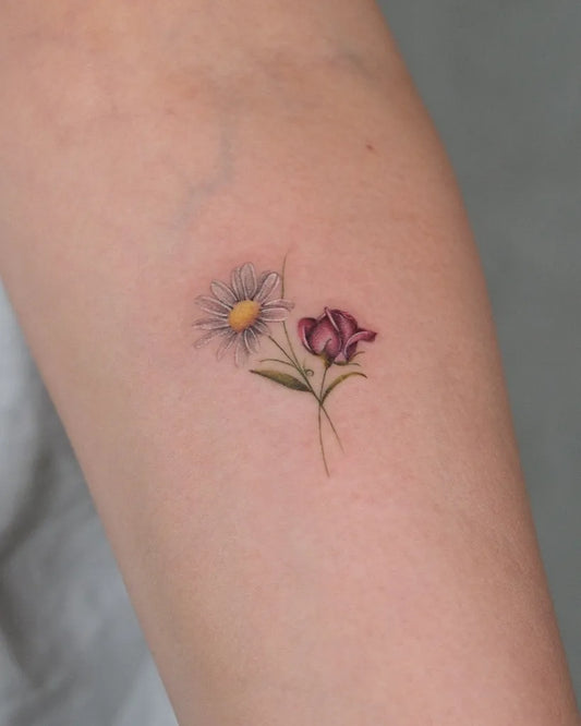 Small Fine Line Daisy and Freesia Tattoo on Women Arm by @ozge.ink