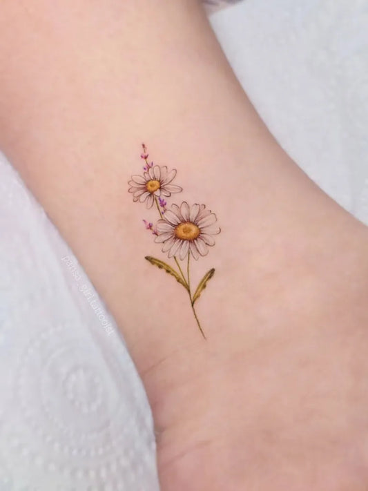 Small Fine Line Daisy and Lavender Tattoo on Women Ankle by @pansa_girl.tattooist