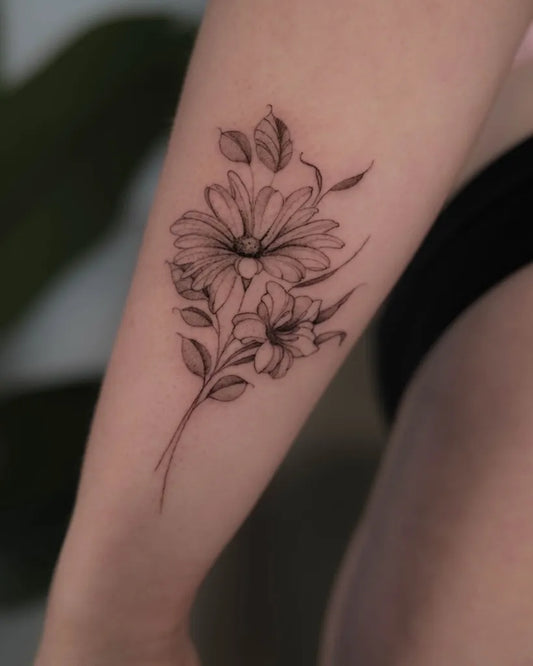Small Fine Line Daisy and Leaves Tattoo on Women Arm by @elena.oldehus