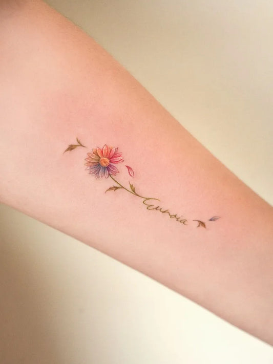 Small Fine Line Daisy and Name Women Arm by @soap.tattoo