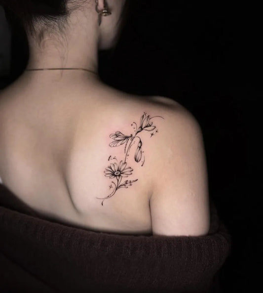 Small Fine Line Daisy and Vines Tattoo on Women Shoulder by @kaki_claratattoos