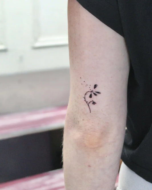 Small Fine Line Daisy in Wind Tattoo on Women Arm by @laineycastro_