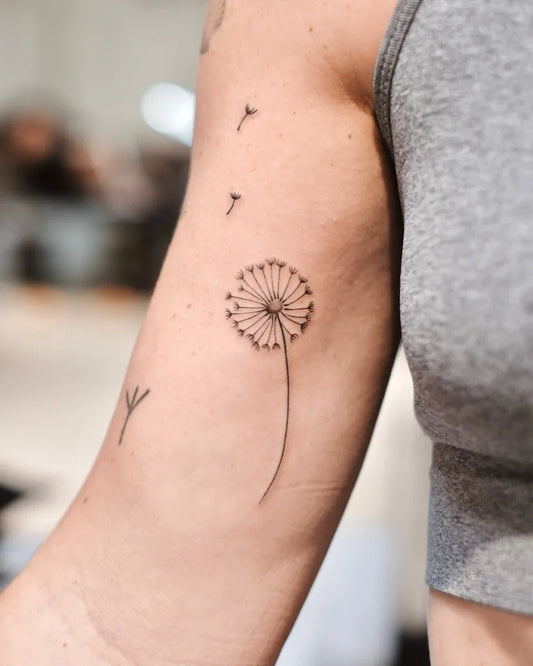 Small Fine Line Dandelion Tattoo on Women Arm by @eagletattooer
