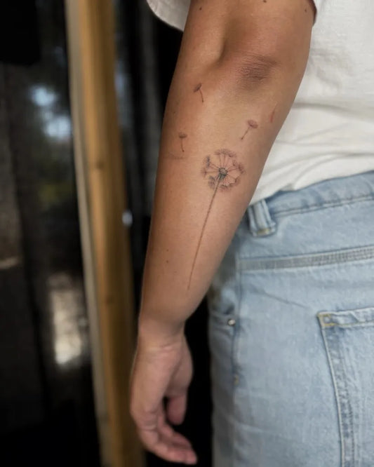 Small Fine Line Dandelion Tattoo on Women Arm by @laskovesmir