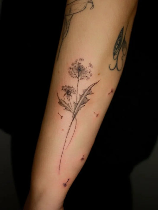 Small Fine Line Dandelion Tattoo on Women Arm by @nadinelee.ink