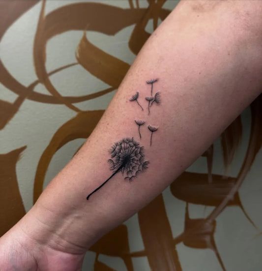 Small Fine Line Dandelion Tattoo on Women Arm by @nikitainks