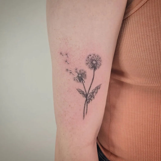 Small Fine Line Dandelion Tattoo on Women Arm by @wildflowers.tattoo