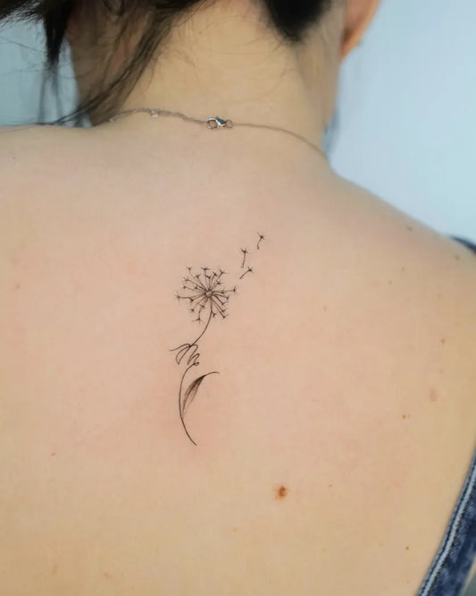 Small Fine Line Dandelion Tattoo on Women Back by @yeowool_tattooer