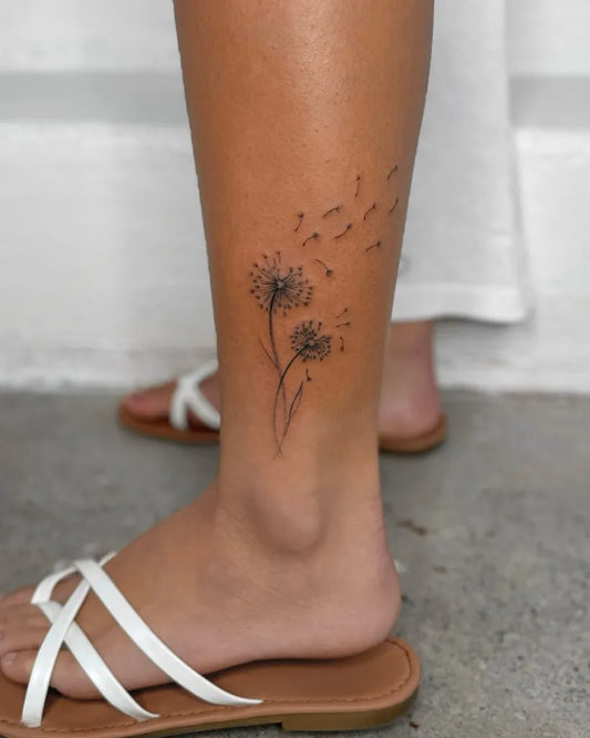 Small Fine Line Dandelion Tattoo on Women Leg by @inkdbysunny