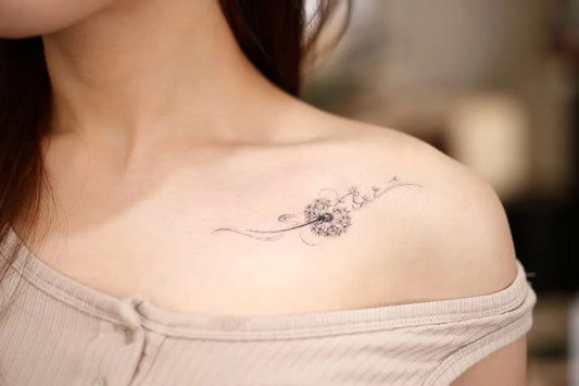 Small Fine Line Dandelion Tattoo on Women Shoulder by @kuri.tattooart