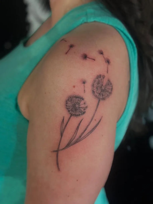 Small Fine Line Dandelion Tattoo on Women Shoulder by @metalroostertattoo