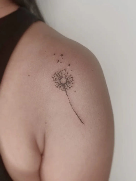 Small Fine Line Dandelion Tattoo on Women Shoulder by @nicaartistry