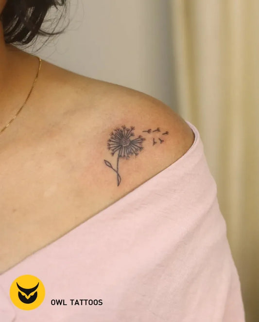 Small Fine Line Dandelion Tattoo on Women Shoulder by @owl_tattoos