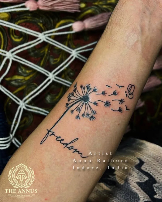 Small Fine Line Dandelion and Freedom Word Tattoo on Women Wrist by @annus_tattoo_indore