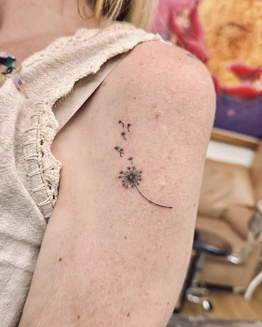 Small Fine Line Dandelion and Seeds Tattoo on Women Shoulder by @bnanatattoo