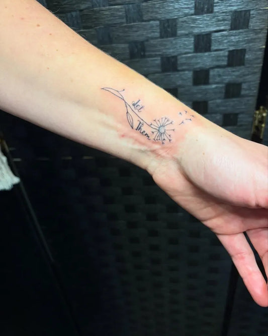 Small Fine Line Dandelion and Seeds Tattoo on Women Wrist by @jzollingerart