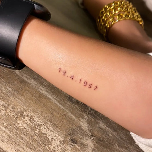 Small Fine Line Date Number Tattoo on Women Arm by @tattooroze1