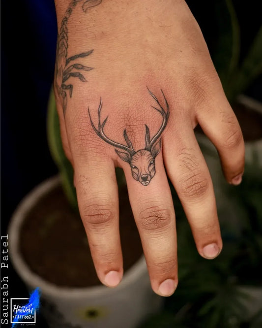 Small Fine Line Deer Skull Tattoo on Men Hand by @blue_heaven_tattooz