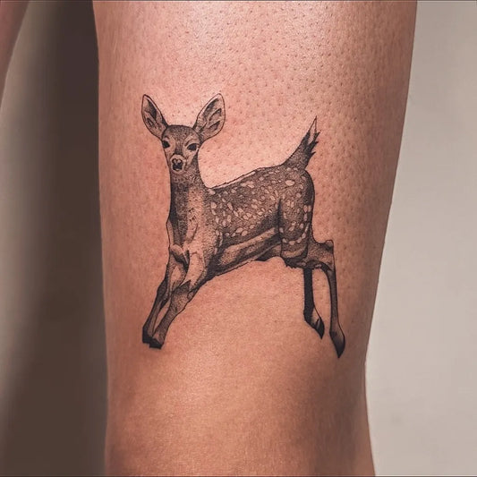 Small Fine Line Deer Tattoo on Women Thigh by @ink.by.kiki