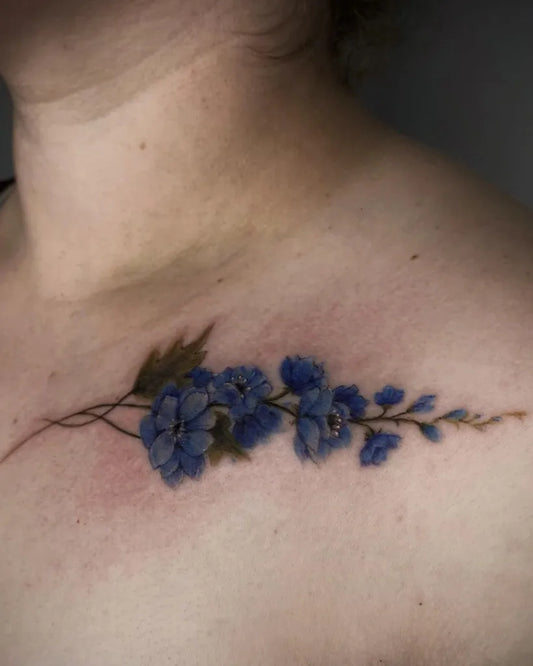 Small Fine Line Delphinium Flowers Tattoo on Women Collarbone by @steffects.ink