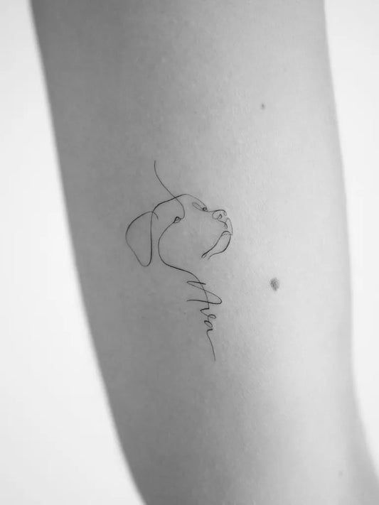 Small Fine Line Dog Tattoo on Women Arm by @mrs.tattoo_