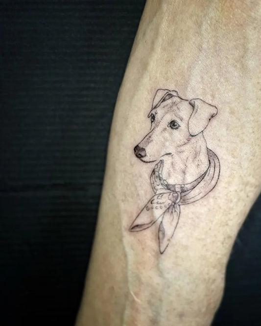 Small Fine Line Dog with Bandana Tattoo on Women Arm by @giadav_finetattoo