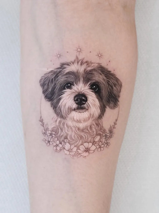 Small Fine Line Dog with Flowers Tattoo on Women Arm by @sana.ink