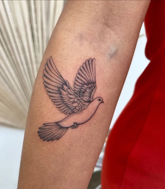 Small Fine Line Dove Tattoo on Women Arm by @inkbeautytherapy