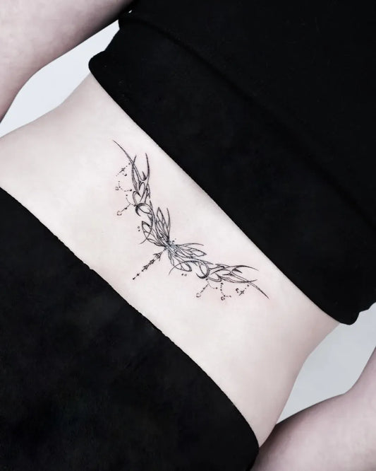Small Fine Line Dragonfly Tattoo on Women Lower Back by @yuna._tattoo