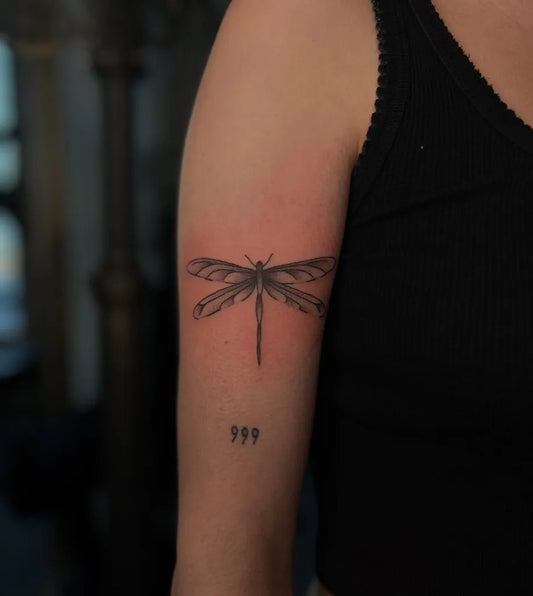 Small Fine Line Dragonfly and 999 Tattoo on Women Arm by @rebeccawtattoos