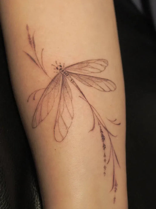 Small Fine Line Dragonfly and Grass on Women Arm Tattoo by @indigo_evolution