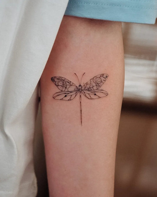 Small Fine Line Dragonfly on Women Arm Tattoo by @bunami.ink