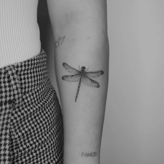 Small Fine Line Dragonfly on Women Arm Tattoo by @luprosil