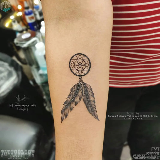 Small Fine Line Dream Catcher with Feathers Tattoo on Women Forearm by @tattoology_studio