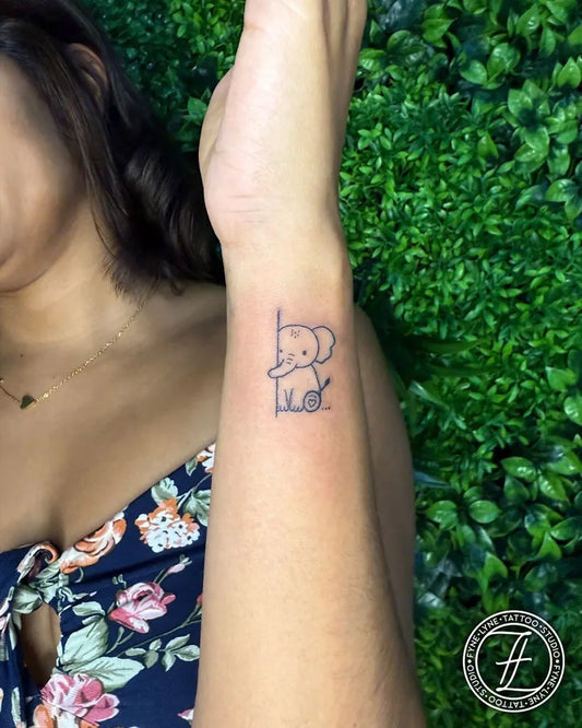 Small Fine Line Elephant Tattoo on Women Wrist by @fyne_lyne_tattoo_studio