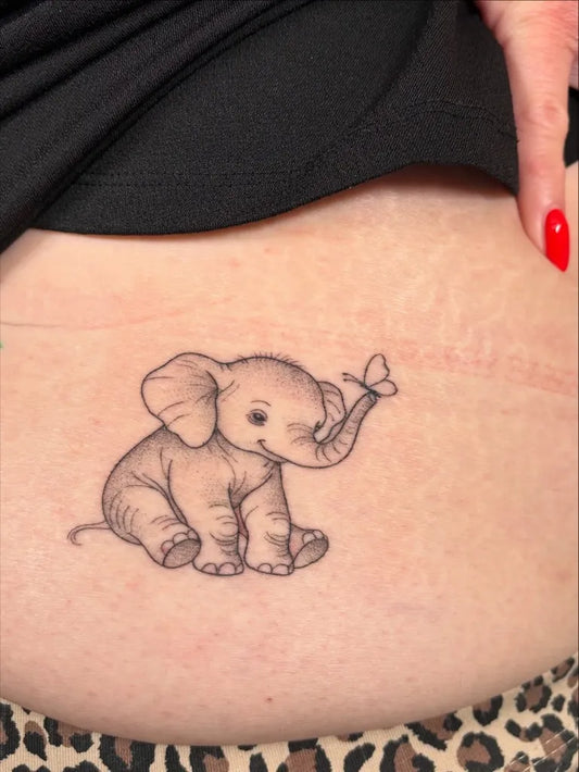 Small Fine Line Elephant and Butterfly Tattoo on Women Hip by @shortys_tattoo