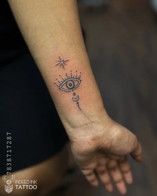 Small Fine Line Evil Eye Stars on Women Wrist Tattoo by @indeedinktattoo
