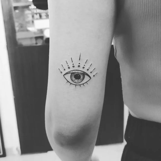 Small Fine Line Evil Eye on Women Arm Tattoo by @yellowltattoos