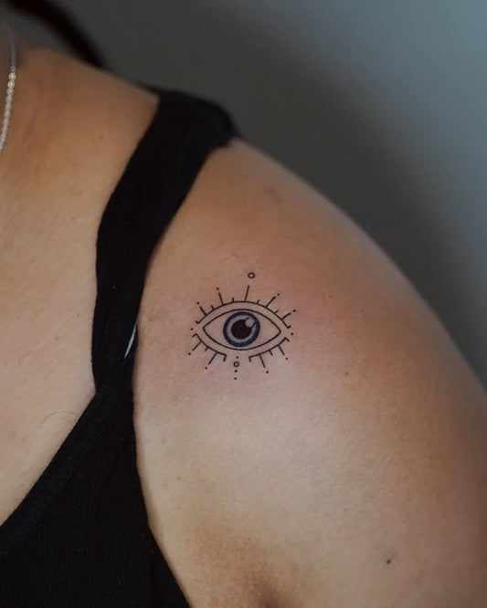 Small Fine Line Evil Eye on Women Shoulder Tattoo by @moonsheentattoo