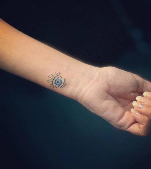 Small Fine Line Evil Eye on Women Wrist Tattoo by @elysiantattooz