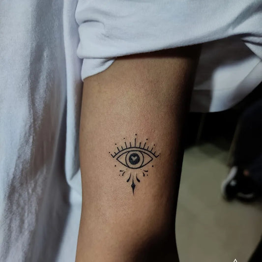 Small Fine Line Evil Eye with Dots and Teardrop on Women Arm Tattoo by @lineart__tattoo