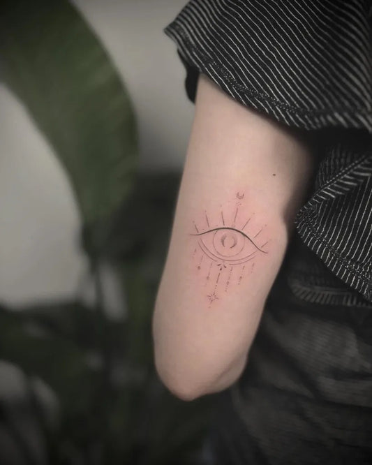 Small Fine Line Evil Eye with Sun Rays on Women Arm Tattoo by @winniec_tattoos