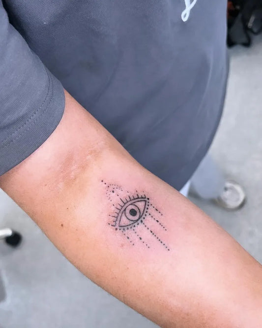Small Fine Line Evil Eye with Temple and Drapes on Women Arm Tattoo by @rochellebatespmua