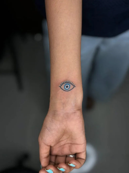 Small Fine Line Eye on Women Wrist Tattoo by @kabirainktattooandpiercing