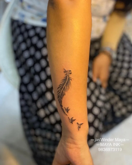 Small Fine Line Feather and Birds Tattoo on Women Forearm by @mayainktattoo