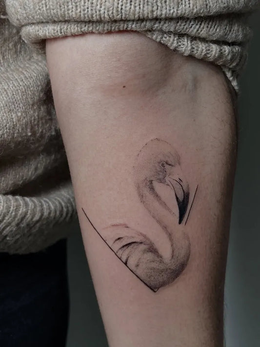 Small Fine Line Flamingo Tattoo on Women Arm by @titare_tattoo