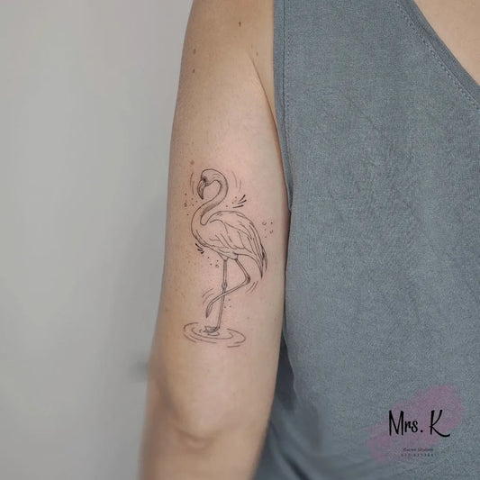 Small Fine Line Flamingo Tattoo on Women Upper Arm by @mrs_k_tatts