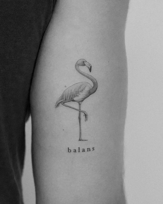 Small Fine Line Flamingo and Balans Tattoo on Women Arm by @lomza_tattoo